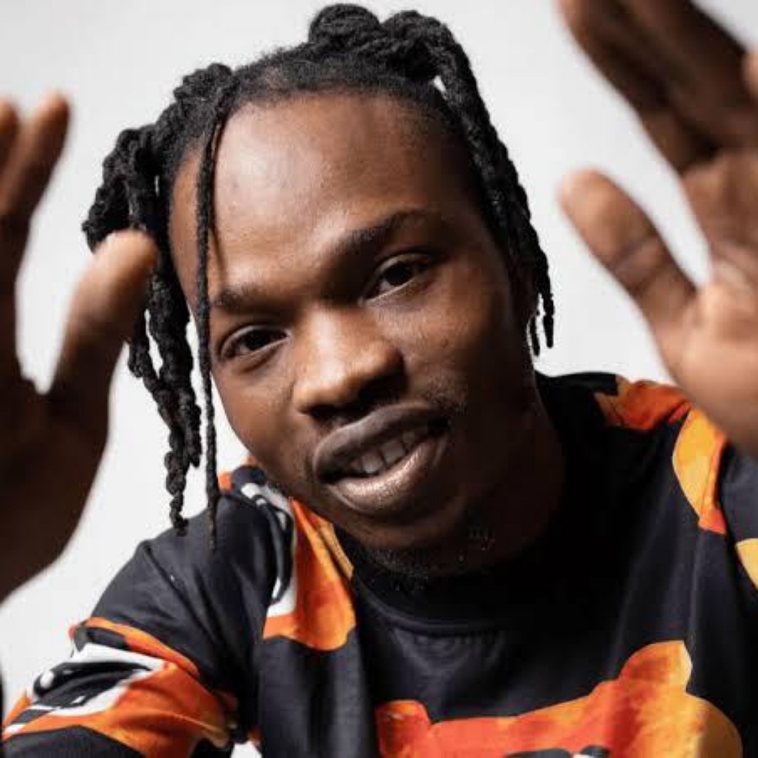 Fan Tattoos Naira Marley's Face On Her Lap